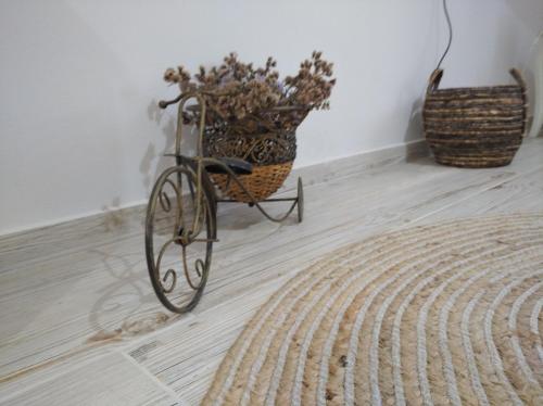 a bike sitting on a floor with a basket at Paliokaliva Home in Roussopoúlion
