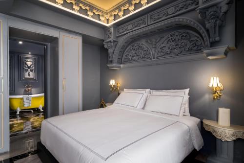 a bedroom with a large white bed in a room at arte by Thomas Chan in Kuala Lumpur
