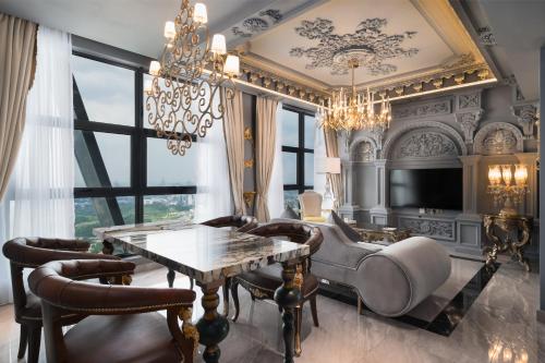 a dining room with a table and chairs and a chandelier at arte by Thomas Chan in Kuala Lumpur