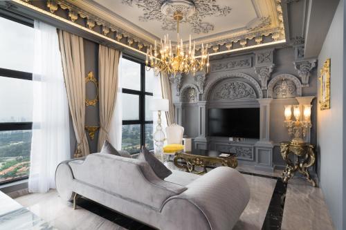 a living room with a couch and a chandelier at arte by Thomas Chan in Kuala Lumpur