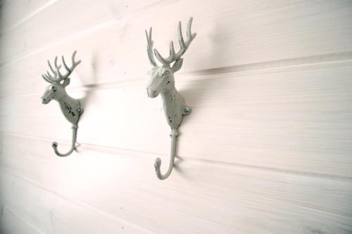 two reindeer decorations hanging on a wall at Lapland Happiness Hillakka 2 a8 in Äkäslompolo