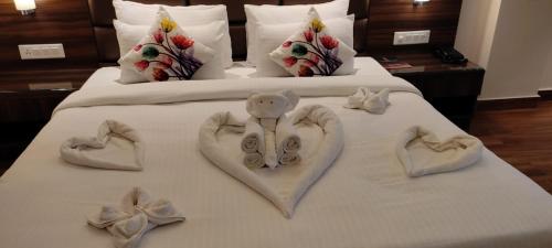 a bed with hearts made out of towels on it at THE DOWNTOWN in Kānpur