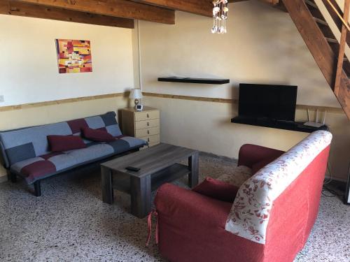 a living room with two couches and a tv at Casa Vacanze "Isole e Tramonti" in Marsala