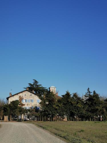 a house sitting on the side of a dirt road at Tenuta San Giorgio in Serravalle Scrivia