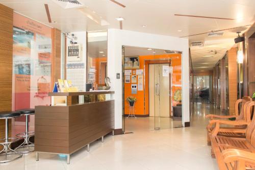a lobby of a store with a counter and chairs at K.V.Mansion in Bangkok