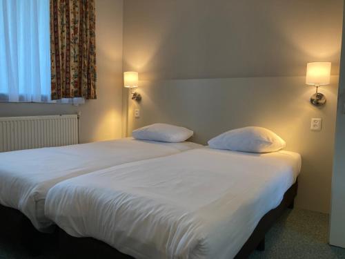 Postel nebo postele na pokoji v ubytování Fletcher Hotel-Restaurant de Witte Brug