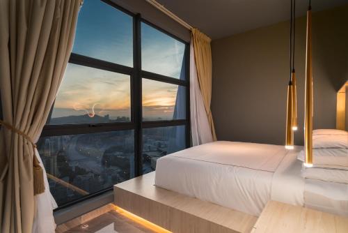 a bedroom with a bed and a large window at arte by Thomas Chan in Kuala Lumpur