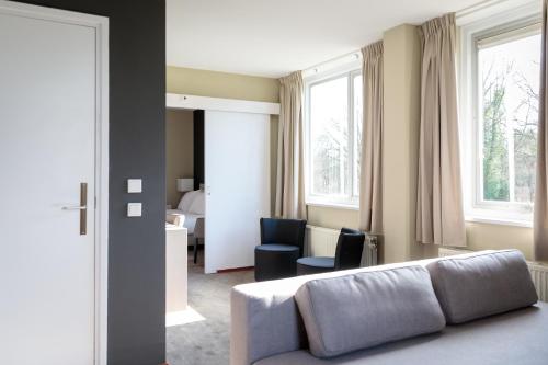 Χώρος καθιστικού στο Fletcher Kloosterhotel Willibrordhaeghe