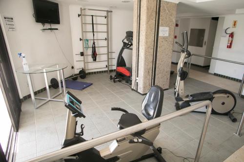 a gym with treadmills and exercise bikes in a room at Alven Hotel by Slaviero Hotéis in Joinville