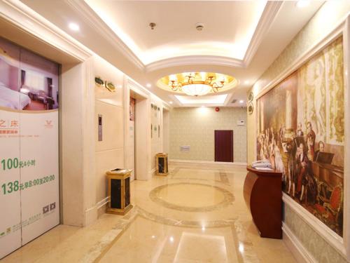 a hallway in a building with a painting on the wall at Vienna Hotel CHangsha Bayi Bridge Hefu in Changsha