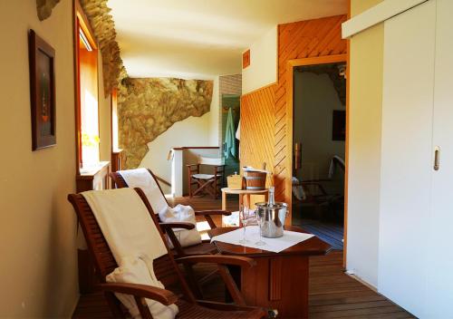 a room with chairs and a table and a room with a dining room at Hotel Baltaci U Náhonu in Zlín