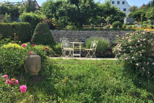 a garden with a table and chairs and flowers at Schönste Location in Würzburg in Würzburg