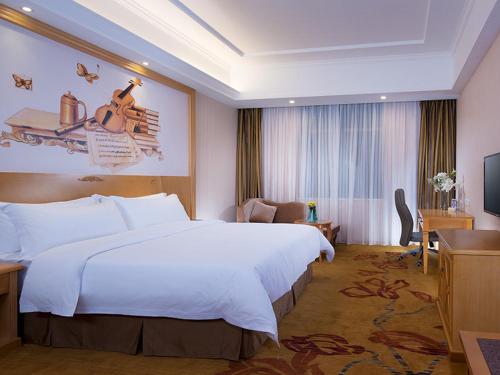 מיטה או מיטות בחדר ב-Vienna Hotel conghua jiangpu street branch