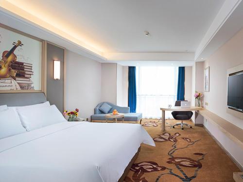 a hotel room with a large bed and a television at Vienna International Hotel (Jiaxing Nanhu Hotel) in Jiaxing