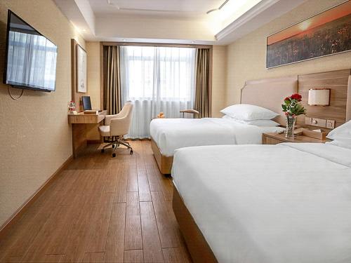 Ένα ή περισσότερα κρεβάτια σε δωμάτιο στο Vienna Hotel 3 best Wuwei City south