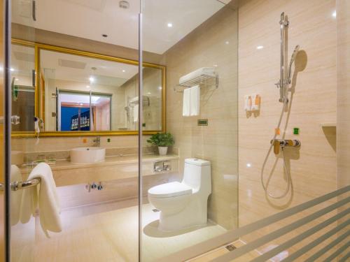 a bathroom with a shower and a toilet and a sink at Vienna Hotel Chengdu Wenjiang Zhujiang Plaza in Wenjiang