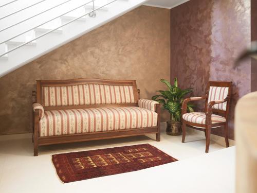 a living room with a couch and two chairs at Hotel Europeo Alpine Charme & Wellness in Pinzolo