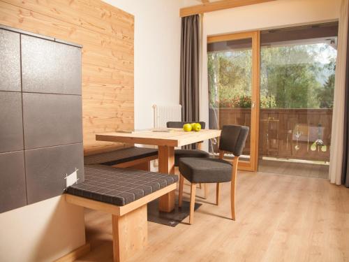 a kitchen and dining room with a table and chairs at Hotel Europeo Alpine Charme & Wellness in Pinzolo