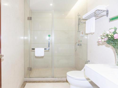 a bathroom with a shower with a toilet and a sink at Vienna Hotel Ningbo Ninghai in Shang-ts'un