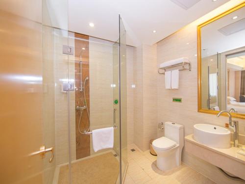 a bathroom with a shower and a toilet and a sink at Vienna Hotel Guangzhou Panyu Huanan Country Garden in Guangzhou