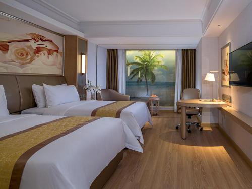 a hotel room with two beds and a desk at Vienna International Hotel (Changfeng Park Shop, Jinshajiang Road, Shanghai) in Shanghai