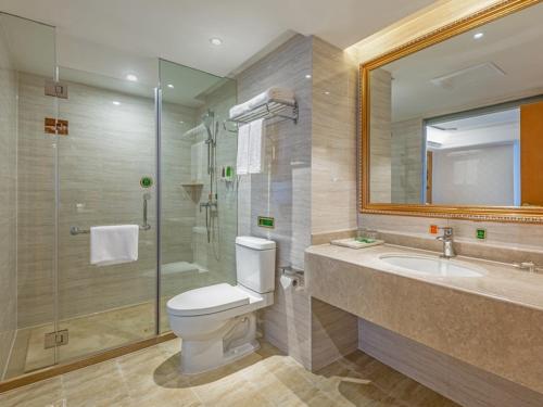 a bathroom with a toilet and a shower and a sink at Vienna Hotel (Mulian West Road Shop, Changsha) in Changsha