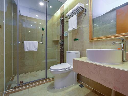 a bathroom with a toilet and a shower and a sink at Vienna Hotel Nanjing Olympic Sports Center in Nanjing