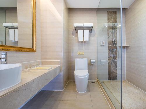 uma casa de banho com um WC, um lavatório e um chuveiro em Vienna 3 Best Hotel Guangzhou Panyu Jinjiang Ave em Guangzhou