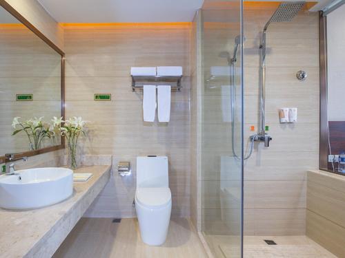 a bathroom with a toilet and a sink and a shower at Vienna Classic Hotel Guangzhou Yanling Road in Guangzhou