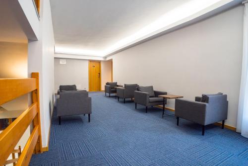 a waiting room with chairs and tables in a building at Hotel Palatinus in Sopron