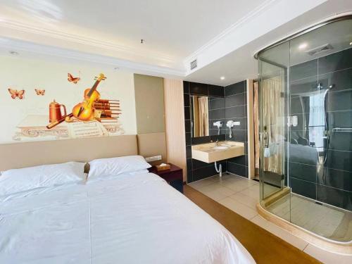 a bedroom with a large white bed and a glass shower at Vienna Hotel Suzhou Mudu Changjiang No 1 in Suzhou