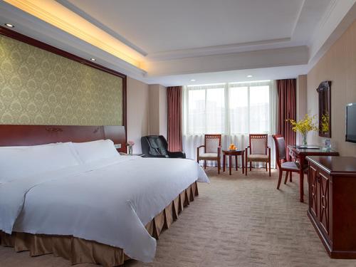Giường trong phòng chung tại Vienna Hotel Longgang Longdong
