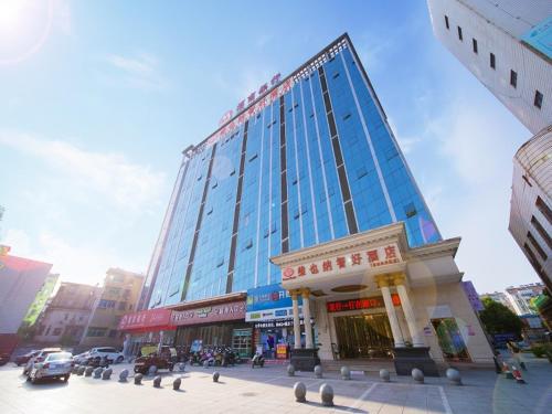 a large glass building in the middle of a city at Vienna Classic Hotel Shizhongshan Avenue in Jiujiang