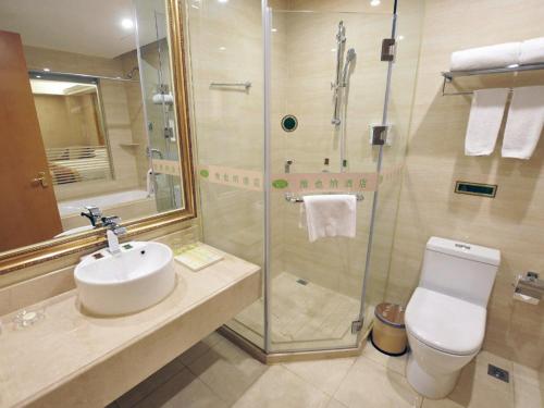 a bathroom with a shower and a sink and a toilet at Vienna Hotel Qidong South Gongyuan Road in Qidong