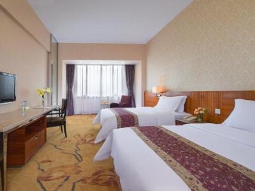 Un ou plusieurs lits dans un hébergement de l'établissement Vienna International Hotel - Foshan Haiyue Branch