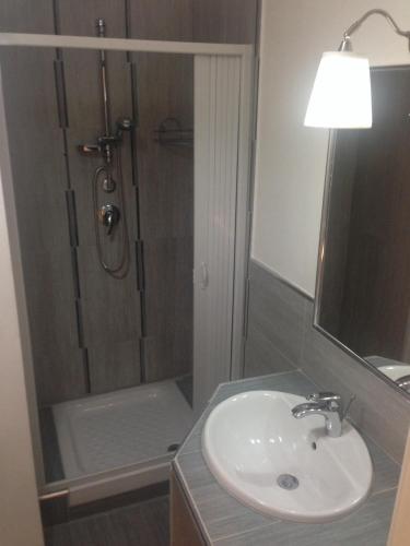 a bathroom with a sink and a shower at Casa Di Amici in Caltanissetta