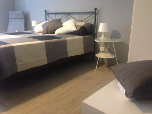 a bedroom with a bed with pillows and a table at Casa Di Amici in Caltanissetta