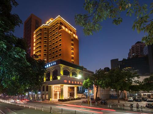 a building on a city street at night at Vienna Hotel Zhongshan West District in Zhongshan
