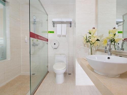 a bathroom with a sink and a toilet and a shower at Vienna Hotel Shenzhen Haiwan in Shenzhen