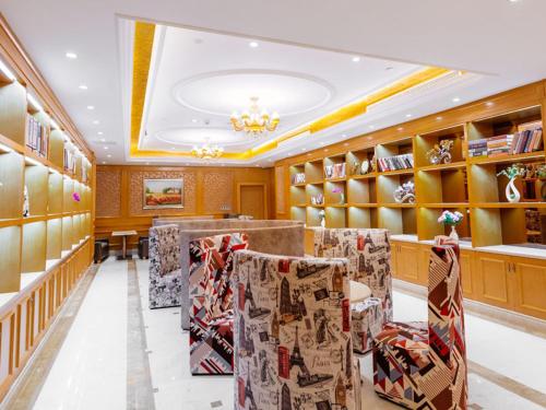 a room with a row of chairs in a store at Vienna International Hotel Shanghai Pudong New District Dishui Lake Univeristy City in Nianbalian
