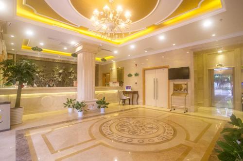 a large room with a chandelier and a lobby at Vienna Hotel Sanya Yalong Bay Qianguqing in Sanya
