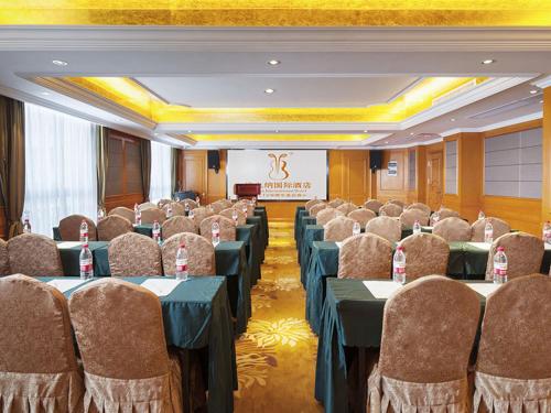a conference room with tables and chairs and a podium at Vienna International Hotel Changsha Shumuling Subway Station in Changsha