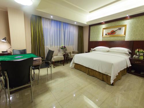 a hotel room with a bed and a pool table at Vienna Hotel Guangzhou Jinshazhou in Nanhai
