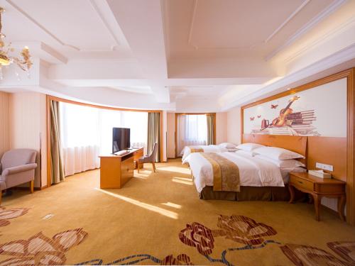 a hotel room with a large bed and a television at Vienna international hotel shanghai pudong airport south store in Nanhui