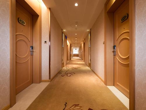 a long hallway with a long corridorngthngthngthngthngthngthngth at Vienna Hotel Foshan Nanhai Avenue Branch in Foshan
