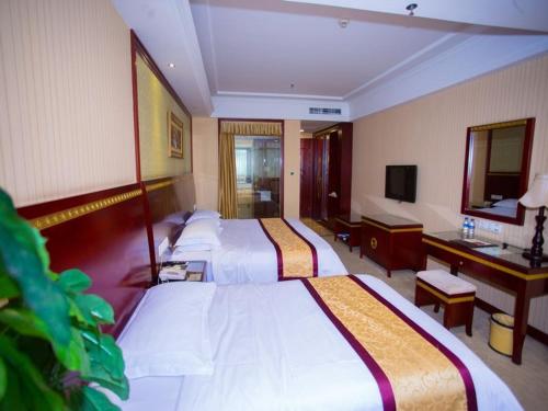 Giường trong phòng chung tại Vienna Hotel Nanchang Hongcheng