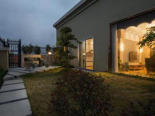 a house with a large window on the side of it at Vienna Hotel Shantou Chaoyang Mianxi Road in Shantou