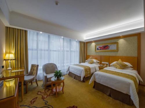 Postel nebo postele na pokoji v ubytování Vienna 3 Best Hotel Liuzhou Yuejiang Road