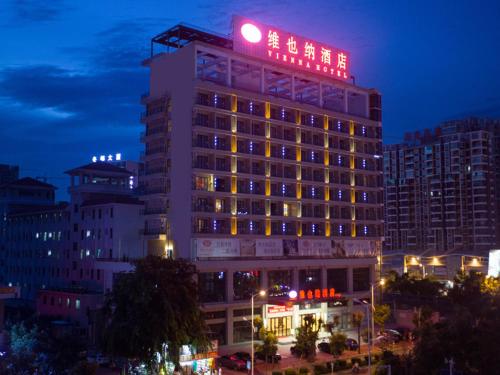 a building with a sign on top of it at night at Vienna Hotel Sanya Sanya Bay in Sanya
