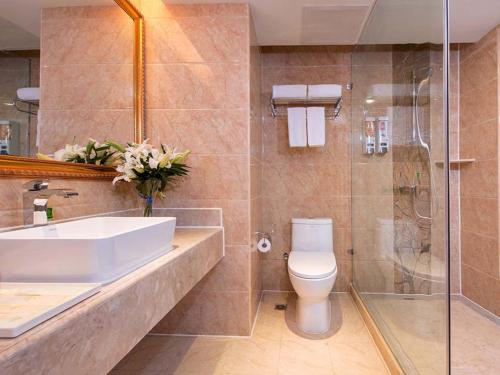 a bathroom with a sink and a toilet and a shower at Vienna Hotel Changde Wuling Avenue in Changde